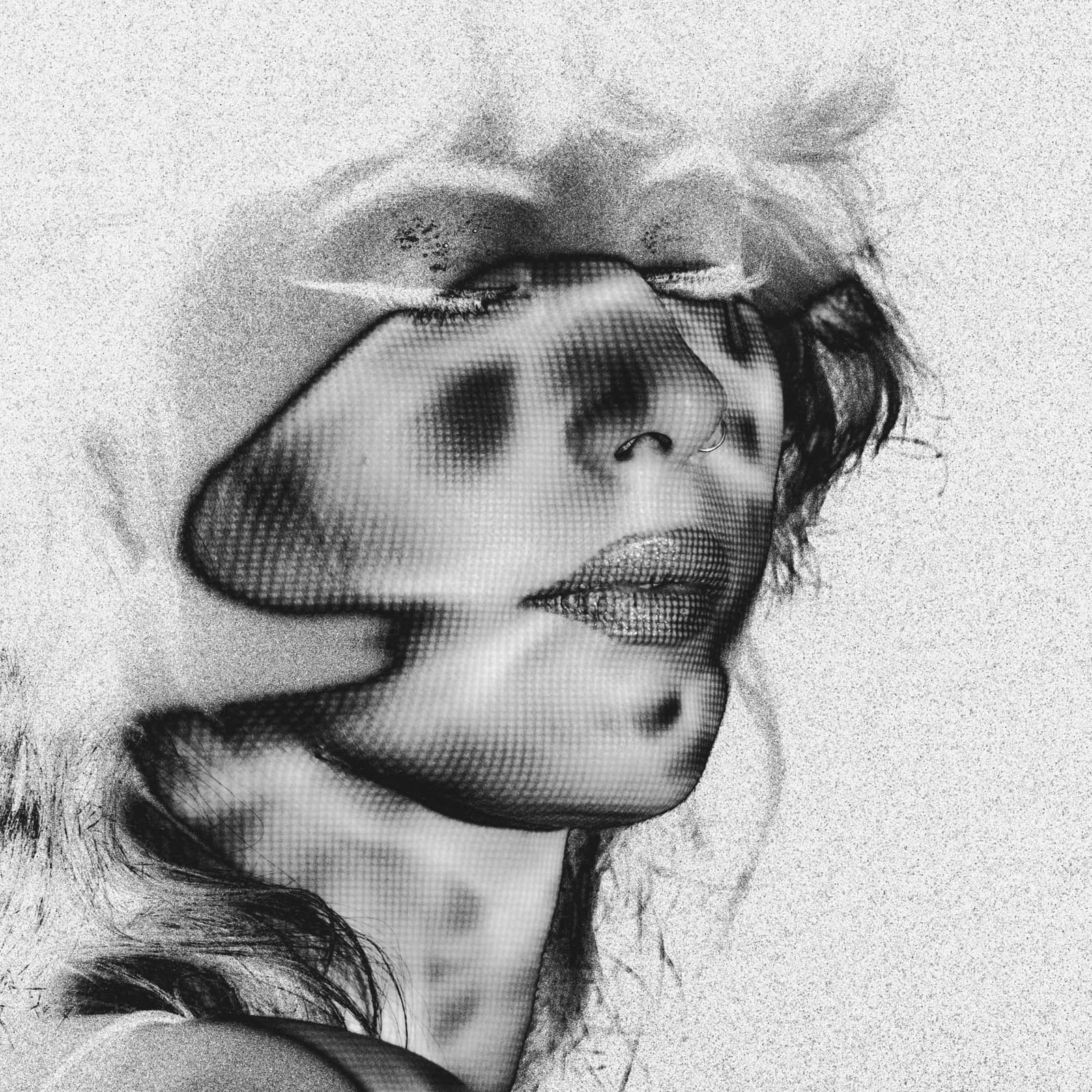 A close-up, black-and-white portrait of a person in profile, illuminated by a projector casting a dot-matrix, solarized pattern across their face. The figure has eyes closed and wears a small hoop piercing in the nose. The lighting creates a high-contrast effect with a grainy, textured overlay across the skin and hair.